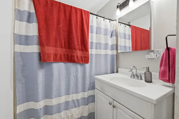 a bathroom with a sink and a shower curtain