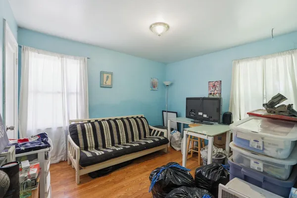 a bedroom with furniture and a tv