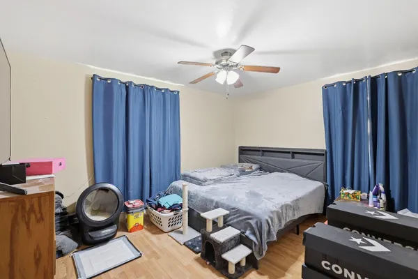 a bedroom with furniture and a mirror