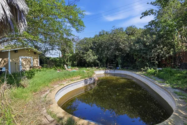 a view of a swimming pool with a yard