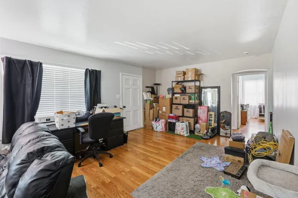 a living room with furniture and a wooden floor