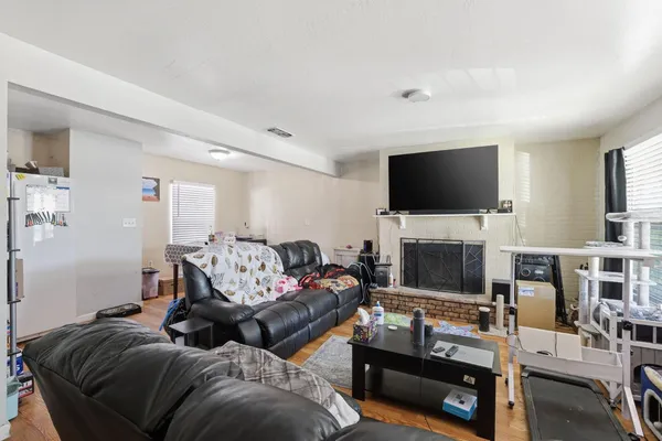 a living room with furniture a flat screen tv and a fireplace
