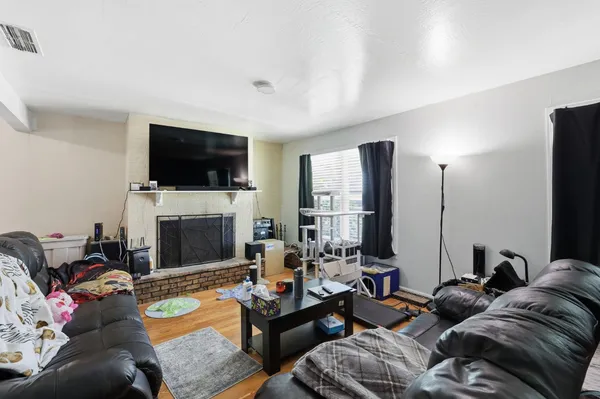 a living room with furniture a flat screen tv and a fireplace