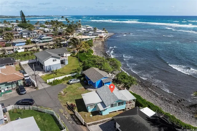 an aerial view of a house with a ocean view