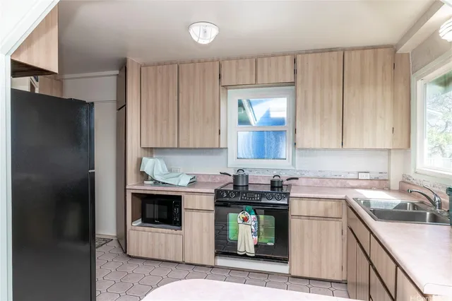 a kitchen with a sink and a refrigerator