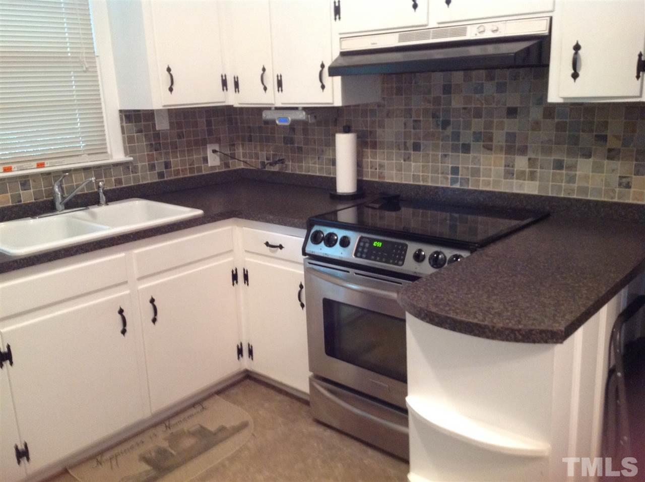 308 Grovemont Road Raleigh, NC 27603 - Photo 3 of 9 a stove top oven sitting inside of a kitchen