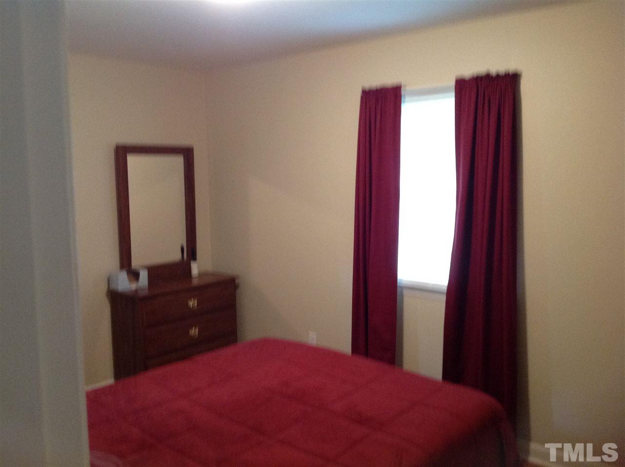 308 Grovemont Road Raleigh, NC 27603 - Photo 7 of 9 a bedroom with a bed and a dresser