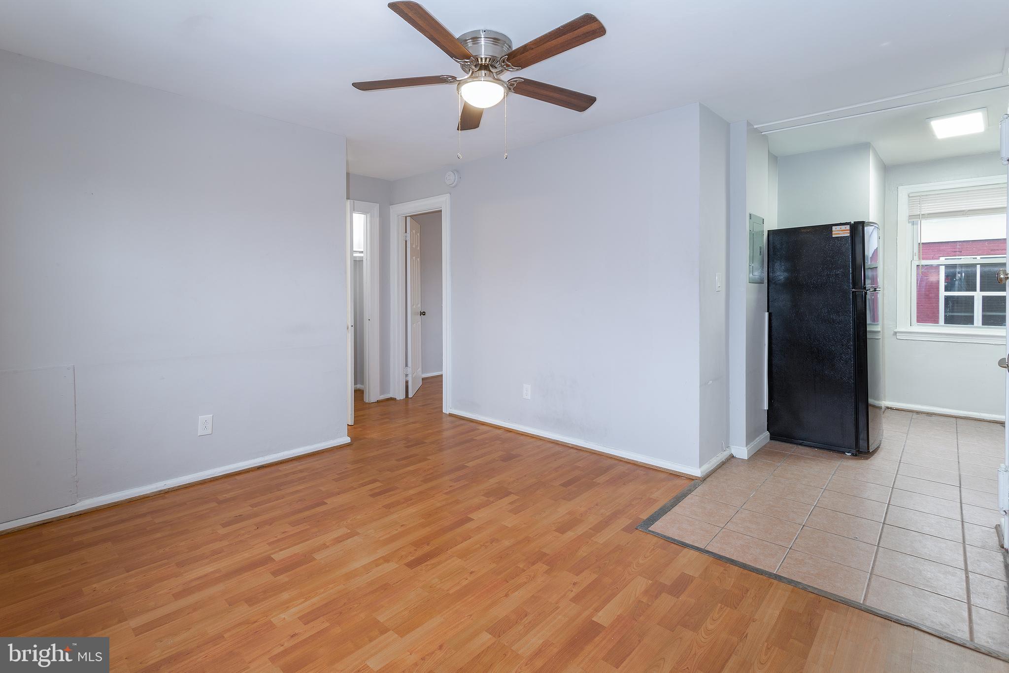 2415 Ontario Road Northwest, Unit 301 Washington, DC 20009 - Photo 12 of 25 a view of an empty room with window and a ceiling fan