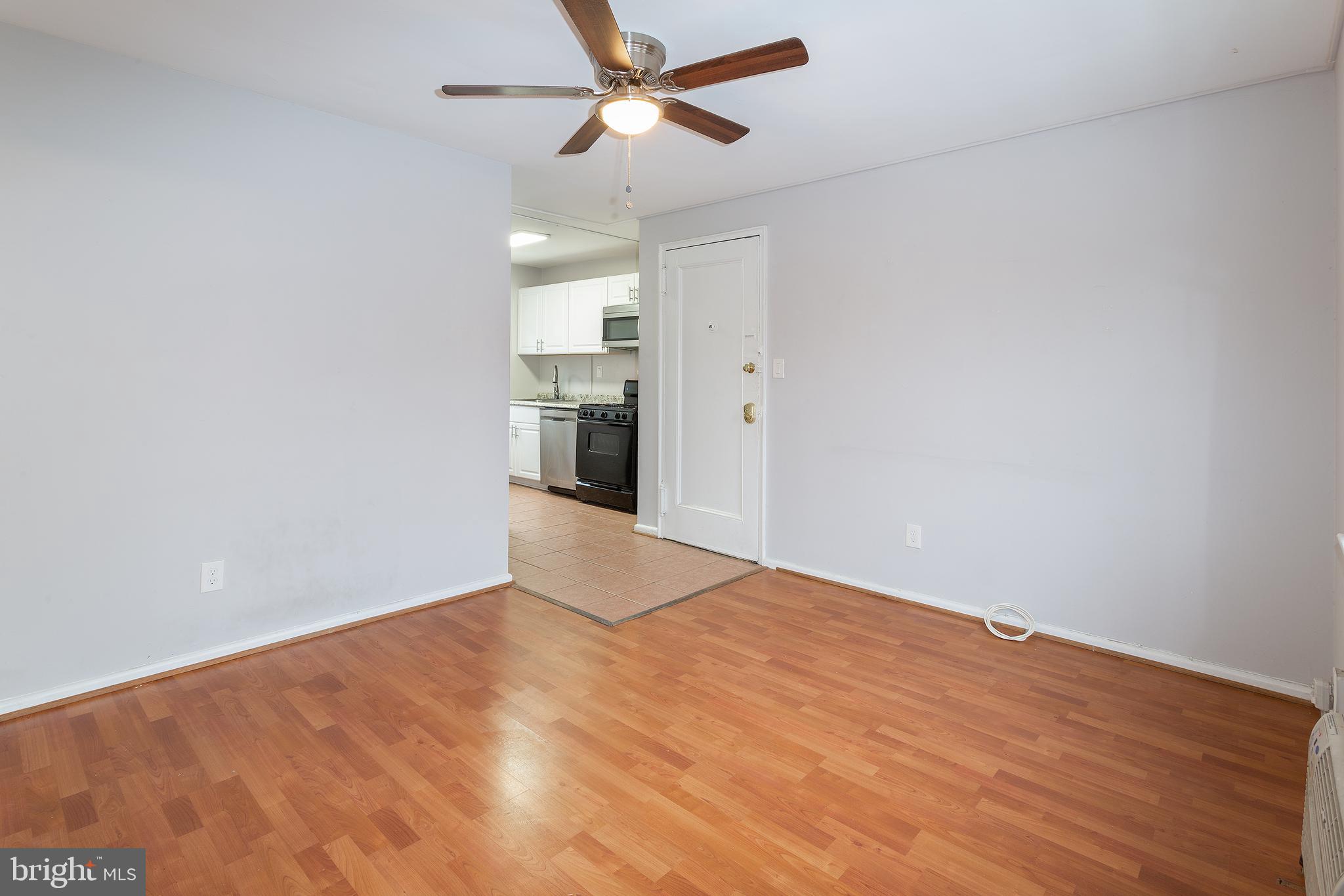 2415 Ontario Road Northwest, Unit 301 Washington, DC 20009 - Photo 14 of 25 a view of empty room with wooden floor and ceiling fan