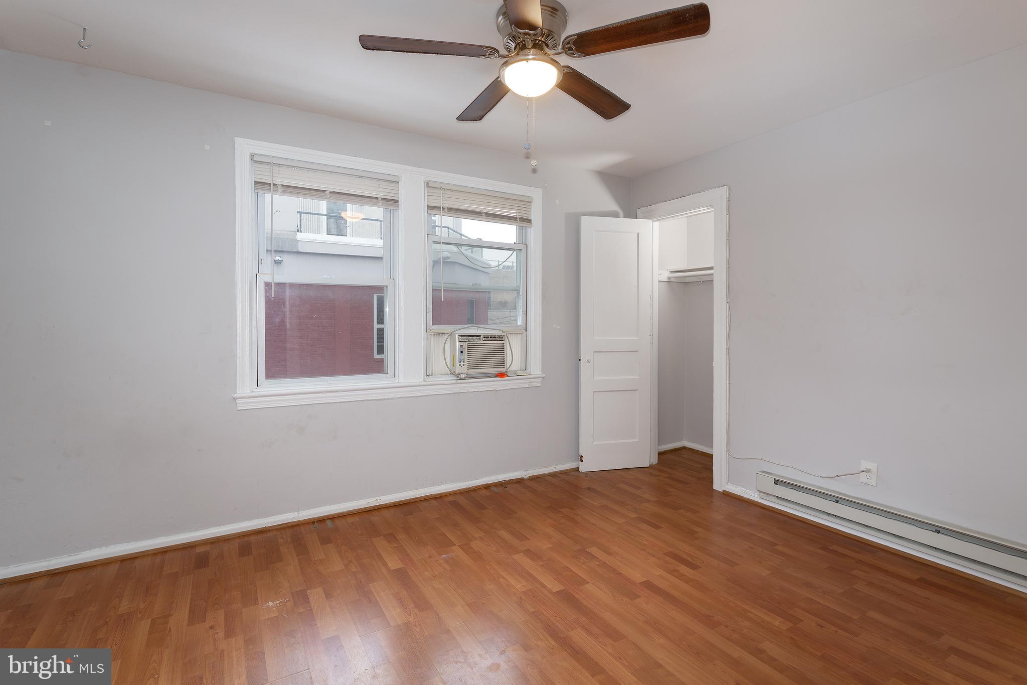 2415 Ontario Road Northwest, Unit 301 Washington, DC 20009 - Photo 16 of 25 a view of empty room with wooden floor and fan