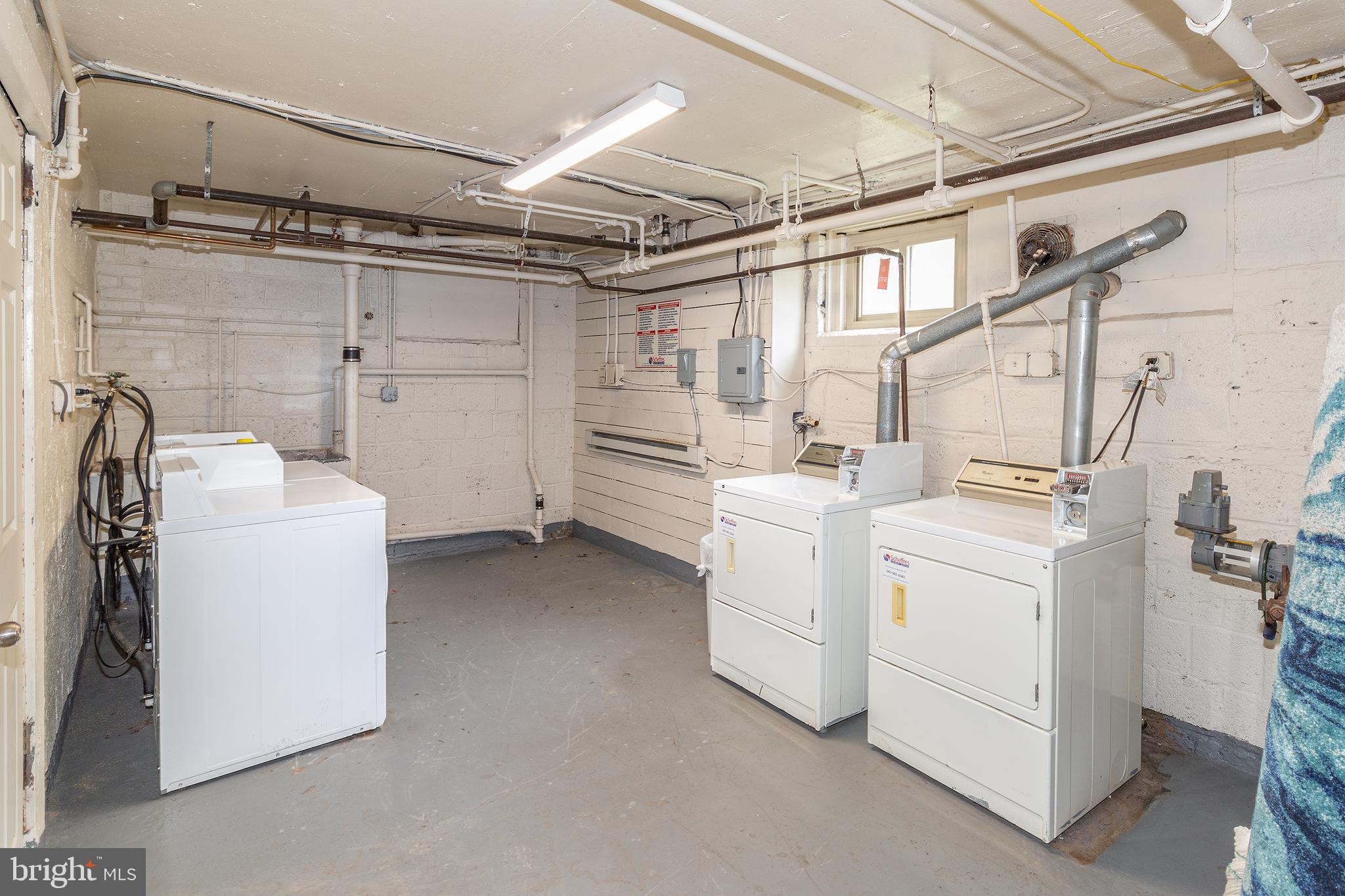 2415 Ontario Road Northwest, Unit 301 Washington, DC 20009 - Photo 23 of 25 a utility room with dryer and washer