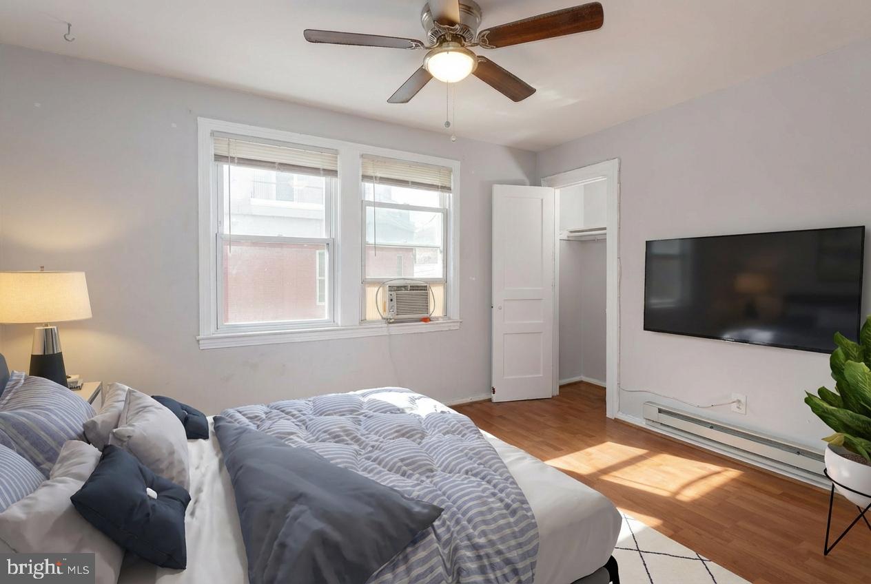 2415 Ontario Road Northwest, Unit 301 Washington, DC 20009 - Photo 3 of 25 a bedroom with a bed and a flat screen tv