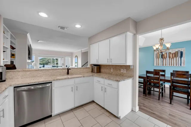 a kitchen with granite countertop cabinets a sink and appliances