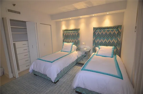 a bedroom with a bed and a mirror