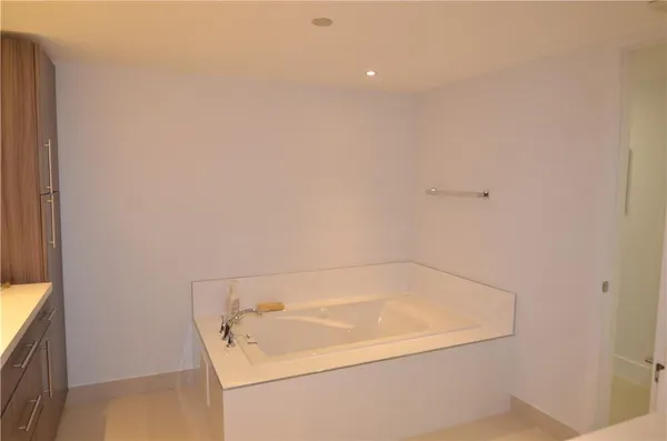 a bathroom with a white bath tub and a shower curtain