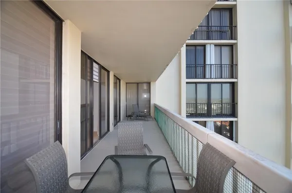 a view of staircase with lots of frames on wall and windows