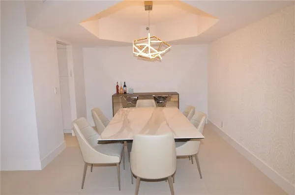 a view of a dining room with a table and chairs