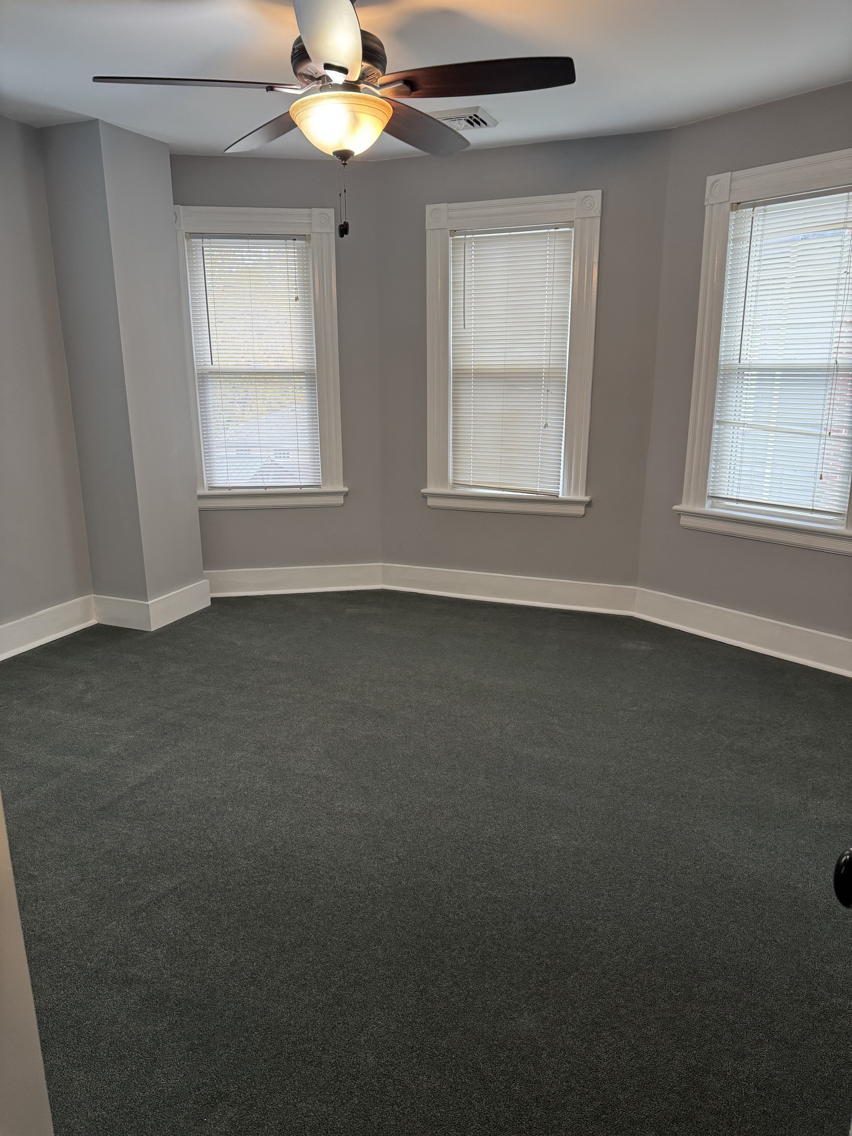 50 Holbrook Street Ansonia, CT 06401 - Photo 5 of 11 an empty room with windows and chandelier fan