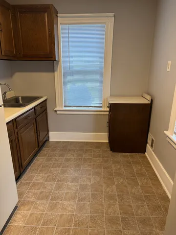 a view of kitchen with window and cabinets