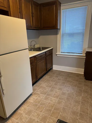 a kitchen with a refrigerator and cabinets