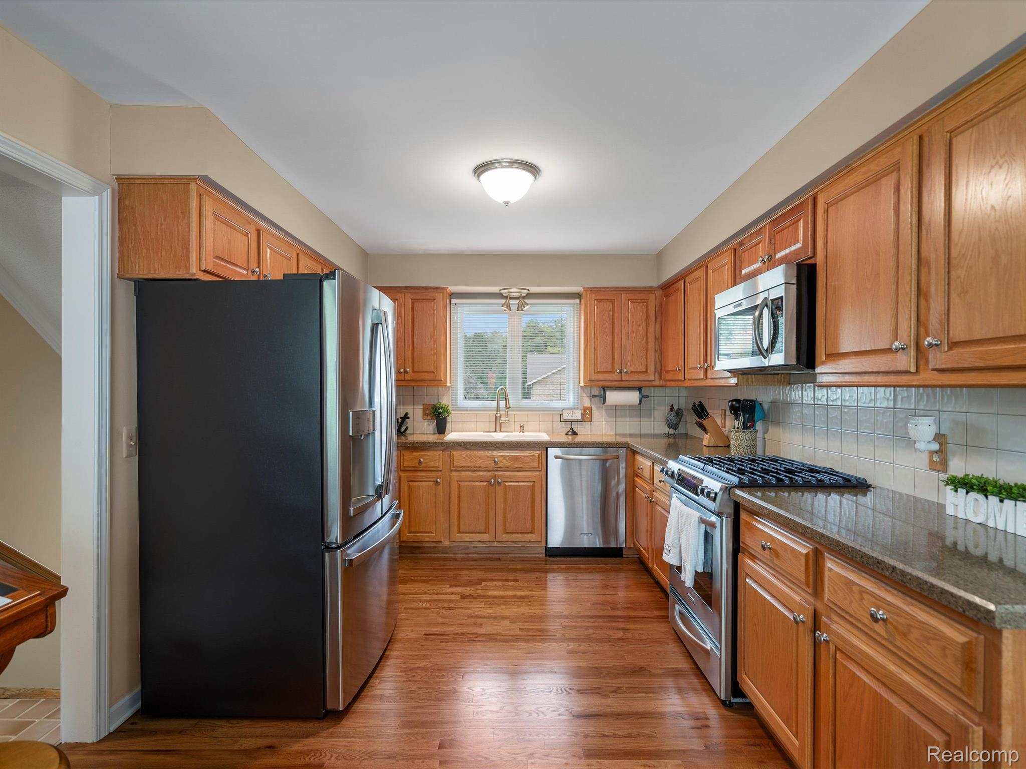 846 Stag Ridge Road Rochester, MI 48309 - Photo 13 of 42 Refaced cabinets and granite counters in kitchen