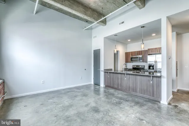 a view of kitchen with refrigerator sink and wooden floor