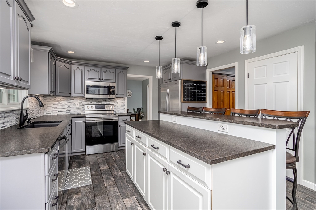 358 Dudley Road Templeton, MA 01468 - Photo 8 of 42 a kitchen with kitchen island granite countertop a stove a sink a center island and cabinets