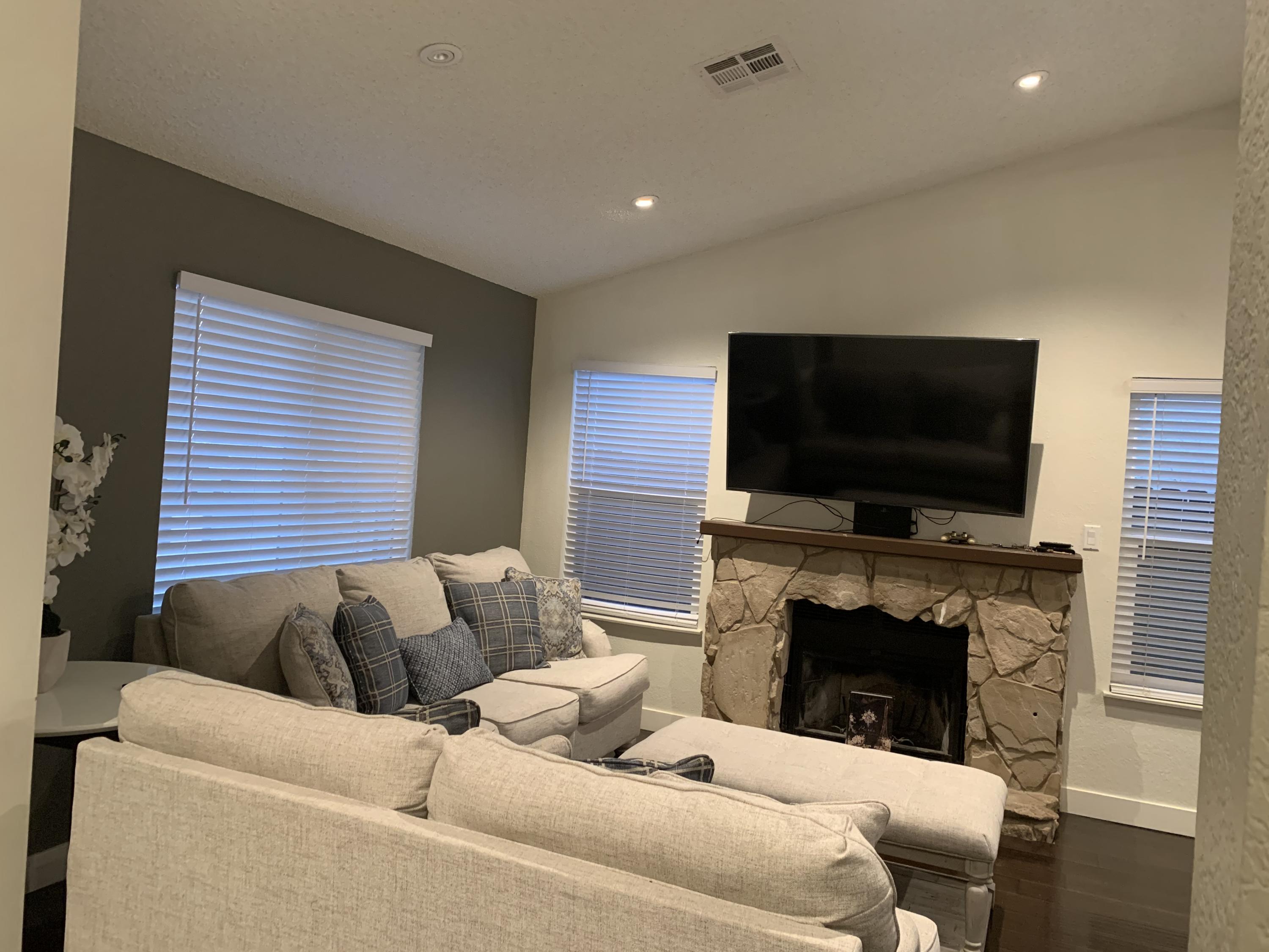 3096 East Avenue R-5 Palmdale, CA 93550 - Photo 2 of 22 a living room with a fireplace and a flat screen tv