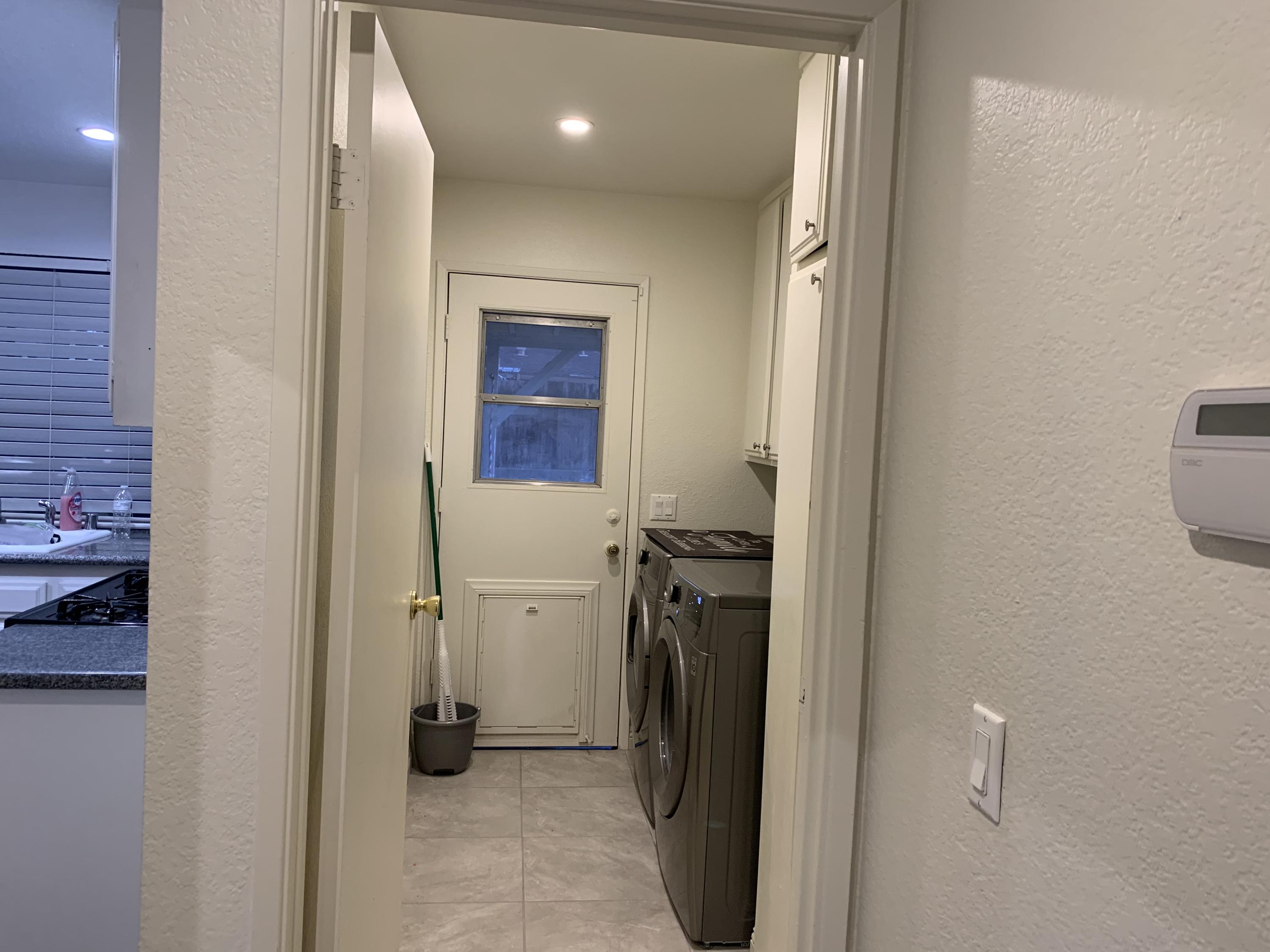 3096 East Avenue R-5 Palmdale, CA 93550 - Photo 11 of 22 a view of a hallway with a refrigerator and a stove
