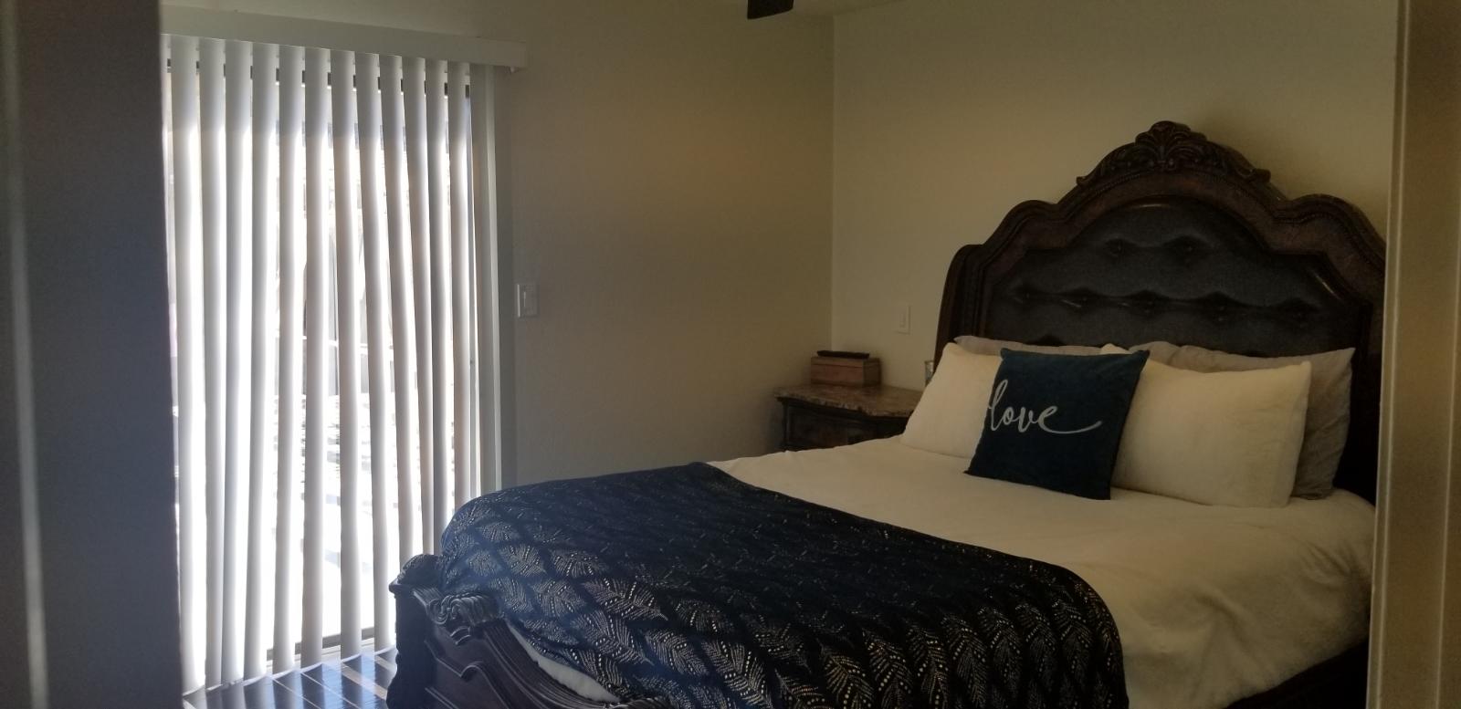 3096 East Avenue R-5 Palmdale, CA 93550 - Photo 15 of 22 a bedroom with a bed and a window