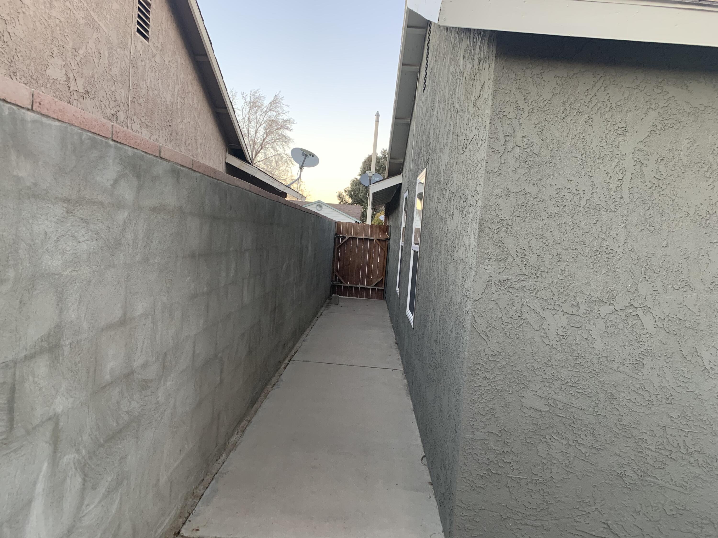 3096 East Avenue R-5 Palmdale, CA 93550 - Photo 20 of 22 a view of a pathway gate of a house