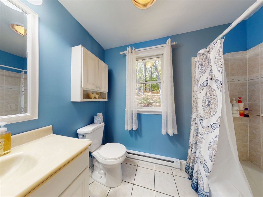 283 Mill Street Gardner, MA 01440 - Photo 13 of 30 a bathroom with a white toilet sitting next to a window