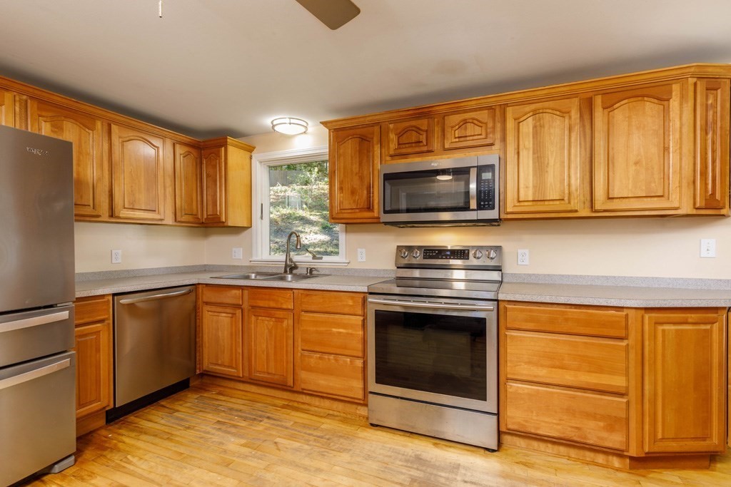 283 Mill Street Gardner, MA 01440 - Photo 3 of 30 a kitchen with granite countertop cabinets stainless steel appliances and a sink