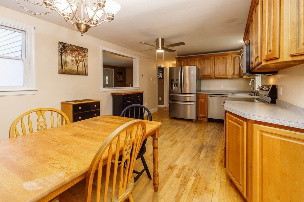 283 Mill Street Gardner, MA 01440 - Photo 4 of 30 a kitchen with stainless steel appliances granite countertop a sink dishwasher a refrigerator with wooden cabinets and floor