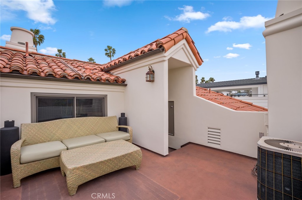 502 1/2 Goldenrod Avenue Corona del Mar, CA 92625 - Photo 14 of 15 a view of a terrace with a couch and potted plants