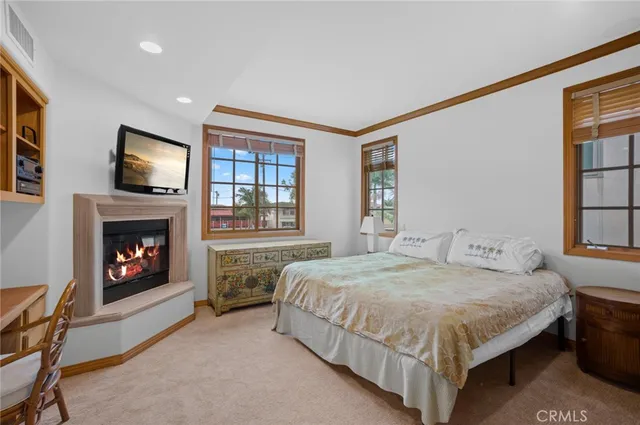 a bedroom with a bed and a fireplace
