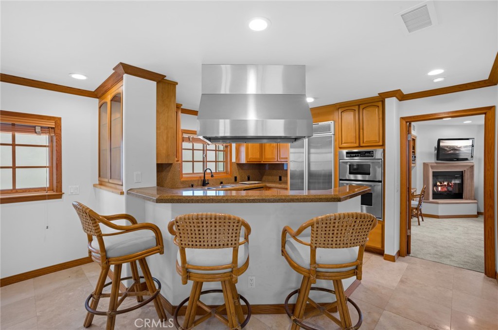 502 1/2 Goldenrod Avenue Corona del Mar, CA 92625 - Photo 9 of 15 a outdoor kitchen with a dining table and chairs