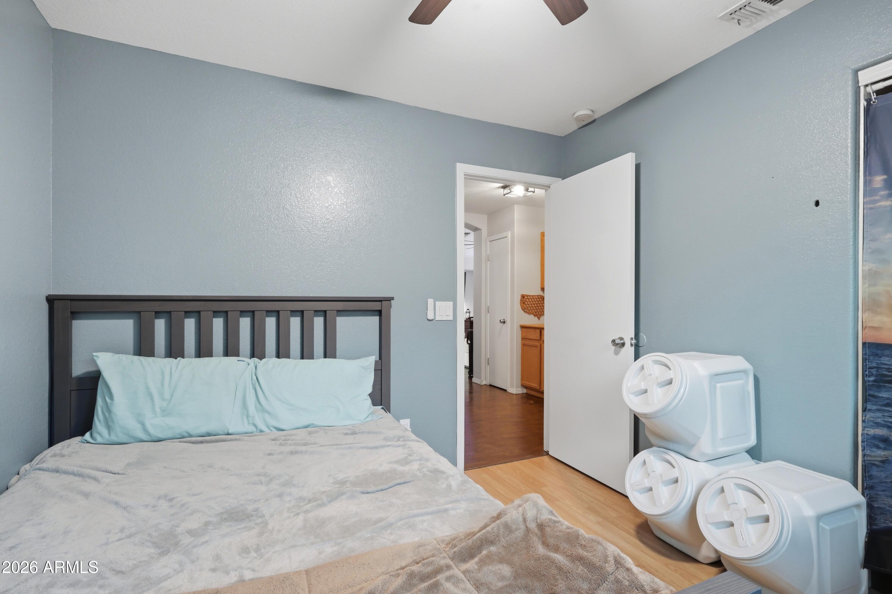 661 North Joshua Tree Lane Gilbert, AZ 85234 - Photo 18 of 47 a bedroom with a bed and a wooden floor