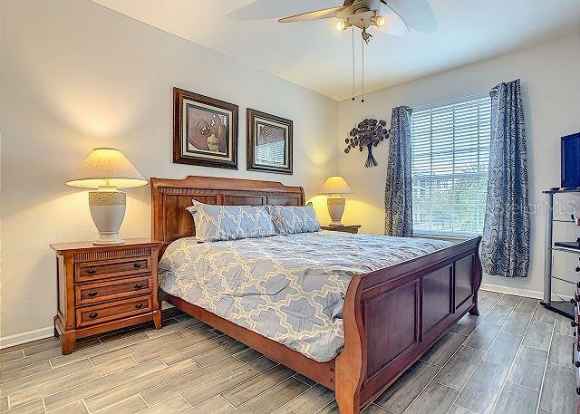 4862 Cayview Avenue, Unit 20909 Orlando, FL 32819 - Photo 13 of 38 a bedroom with a bed and a chandelier
