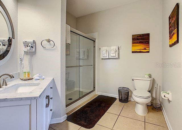 4862 Cayview Avenue, Unit 20909 Orlando, FL 32819 - Photo 16 of 38 a bathroom with a sink toilet and shower