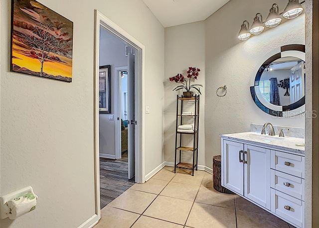 4862 Cayview Avenue, Unit 20909 Orlando, FL 32819 - Photo 17 of 38 a bathroom with a sink and a mirror