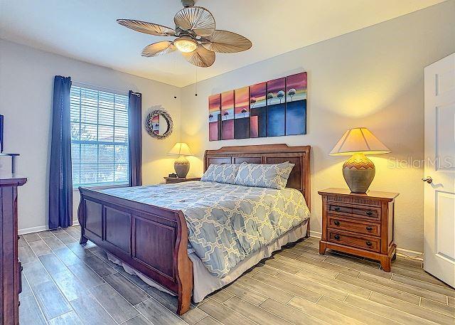 4862 Cayview Avenue, Unit 20909 Orlando, FL 32819 - Photo 18 of 38 a bedroom with a bed dresser and a window