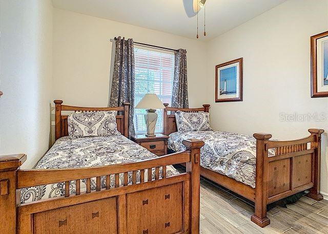 4862 Cayview Avenue, Unit 20909 Orlando, FL 32819 - Photo 21 of 38 a bedroom with a bed and wooden floor