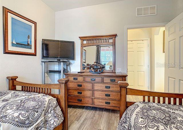 4862 Cayview Avenue, Unit 20909 Orlando, FL 32819 - Photo 22 of 38 a bedroom with a bed and a flat screen tv