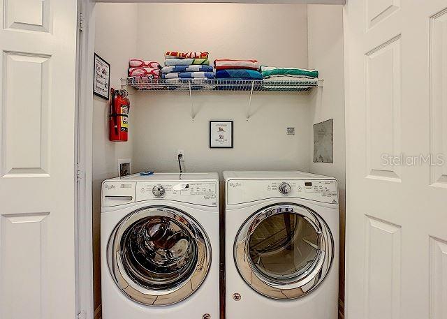 4862 Cayview Avenue, Unit 20909 Orlando, FL 32819 - Photo 26 of 38 a utility room with dryer and washer