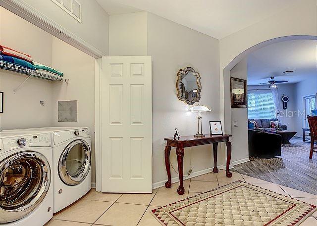 4862 Cayview Avenue, Unit 20909 Orlando, FL 32819 - Photo 27 of 38 a view of a hallway with washer and dryer