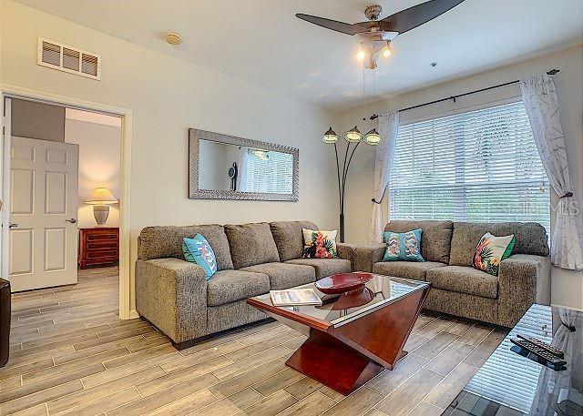 4862 Cayview Avenue, Unit 20909 Orlando, FL 32819 - Photo 6 of 38 a living room with furniture and a window