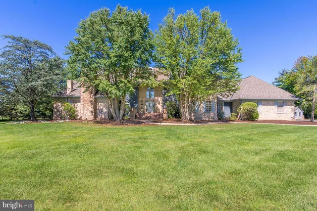 an aerial view of a house with swimming pool and ocean view