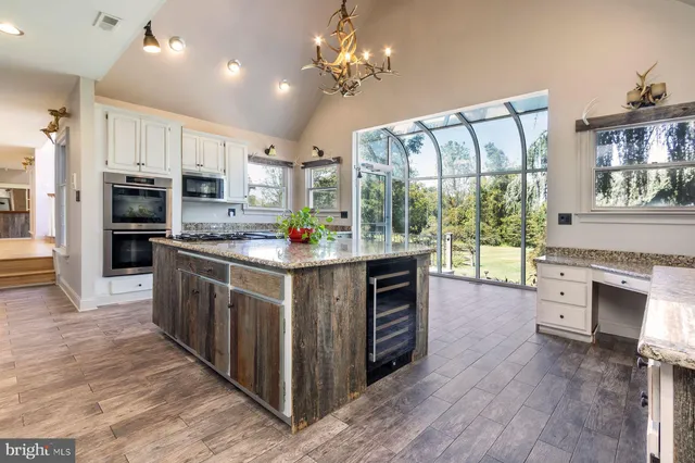 a kitchen with stainless steel appliances a sink stove and cabinets