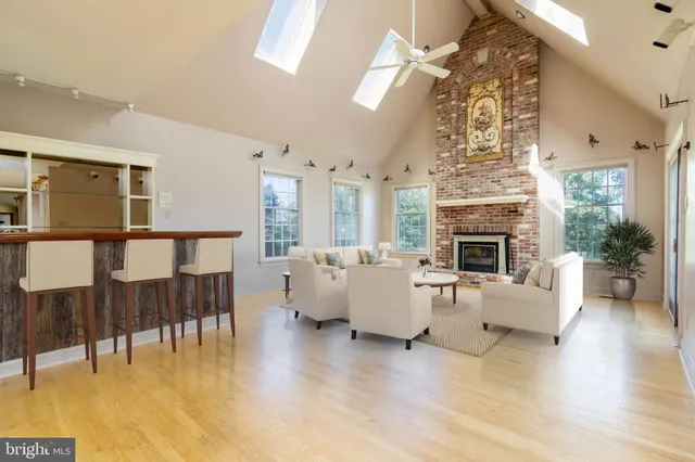 a view of a livingroom with wooden floor and a fireplace